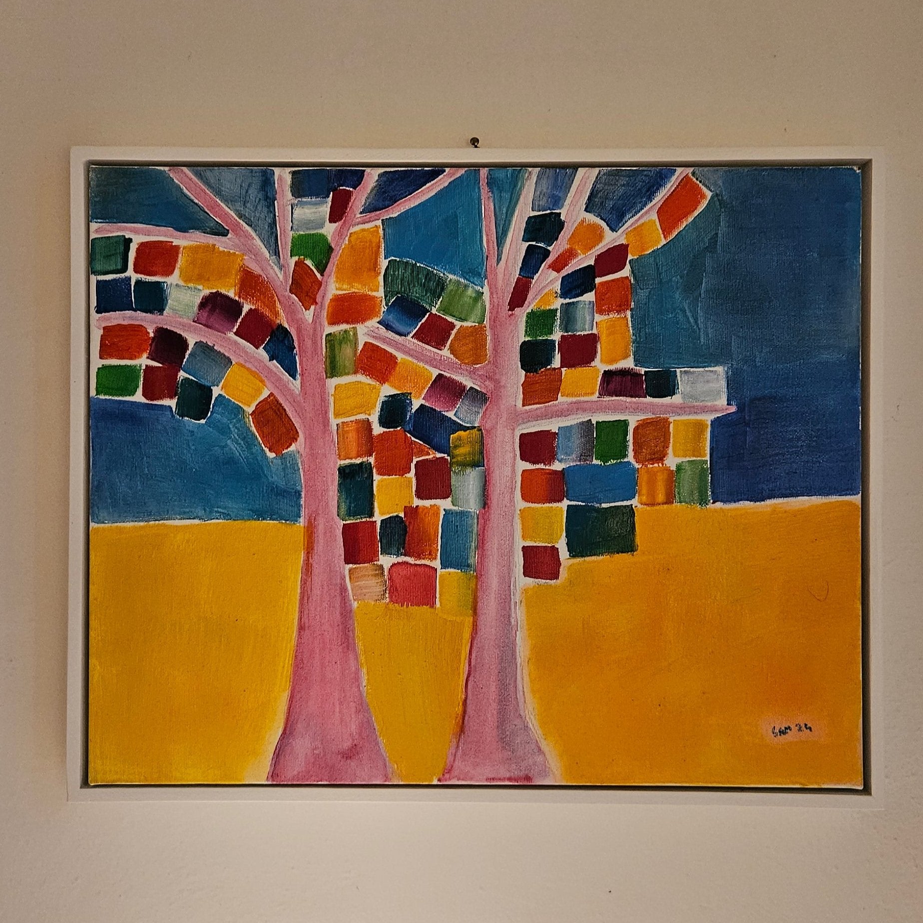 Abstract tree oil painting with blue and yellow background and leaves painted as colorful squares